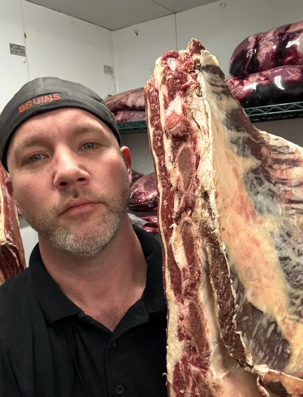 Adam holding a whole beef primal in the cooler at Jaworski Meats, Bristolville Ohio cattle