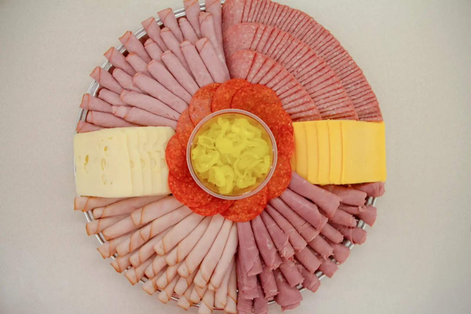 Jaworski Meats party tray with hand-fanned deli meats, Swiss, American cheese, pepperoni, and banana peppers